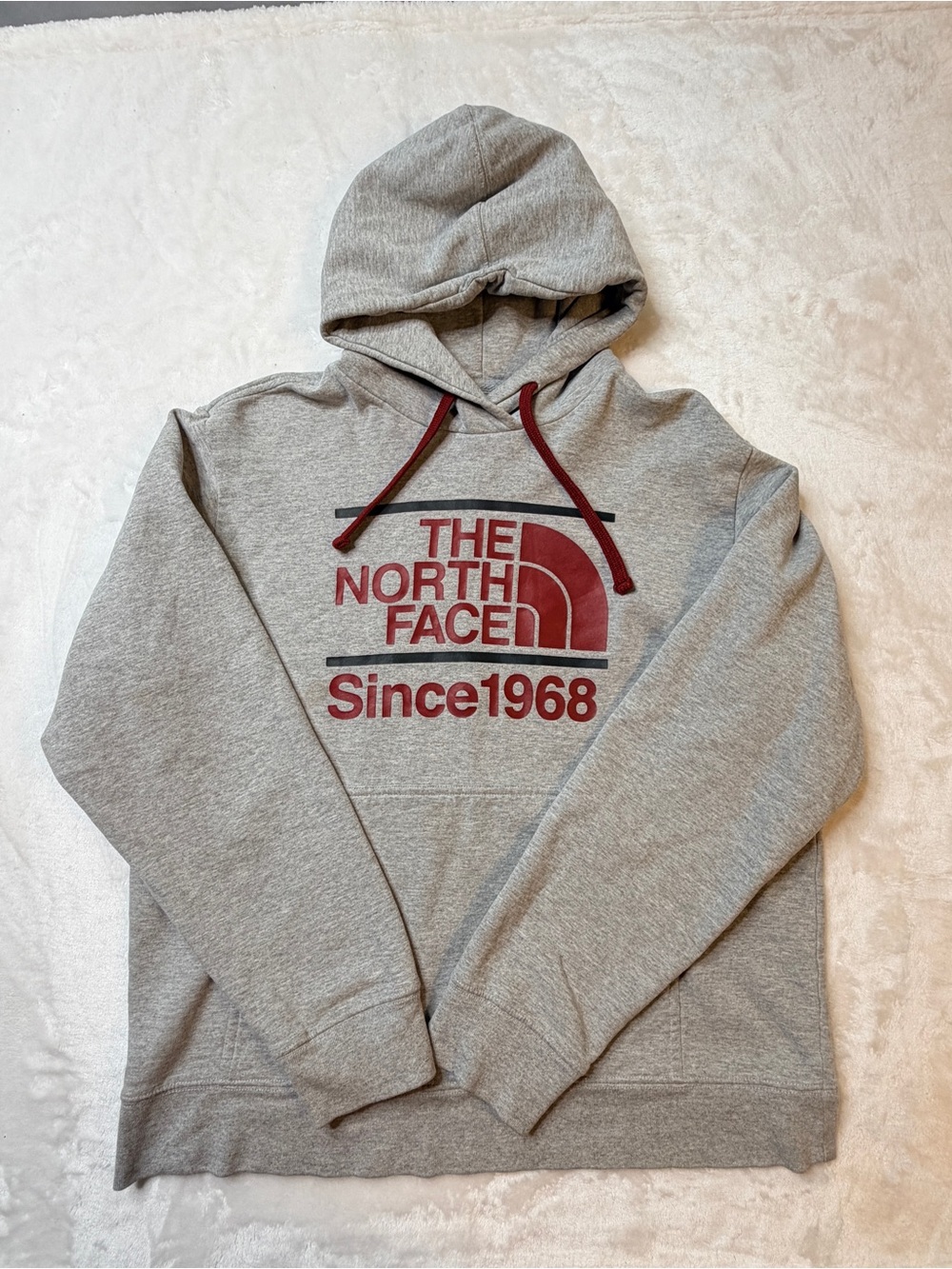 The North Face Gray Pullover Hoodie with Red Logo and Drawstrings
